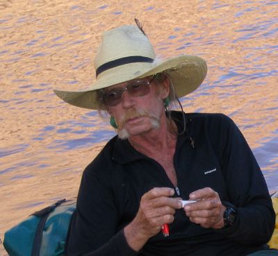 Brian Coombs rolling a cigerette on the Colorado River